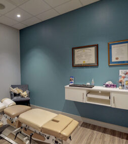 Chiropractor Kanata office with an adjustment table and diplomas on the wall.