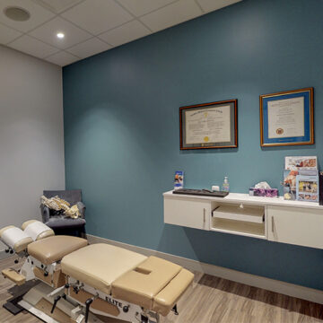 Chiropractor Kanata office with an adjustment table and diplomas on the wall.