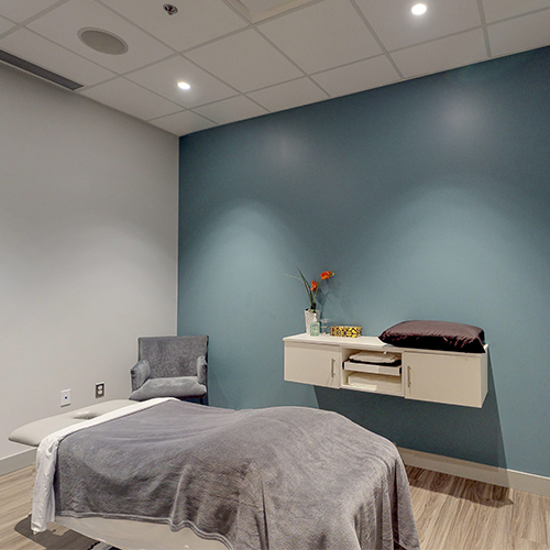 Kanata clinic treatment room with an adjustable table and serene lighting.